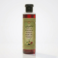 Bottle of herbal hair oil with a green label on a white background