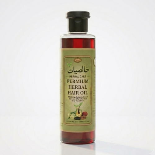 Bottle of herbal hair oil with a green label on a white background